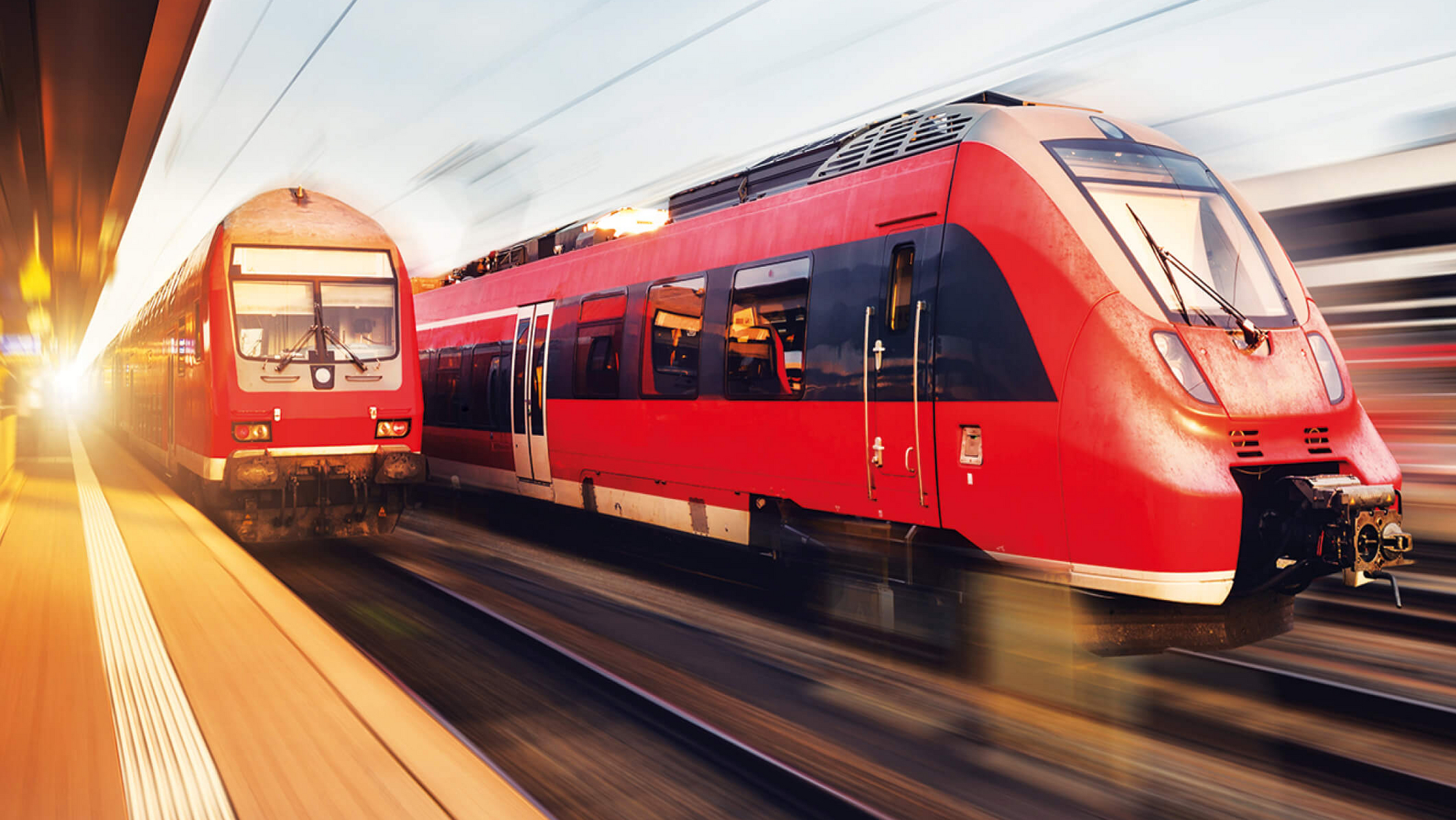 Regionalzüge der Deutschen Bahn fahren am Bahnhof vorbei