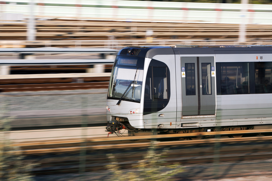 Eine graue U-Bahn fährt von rechts nach links