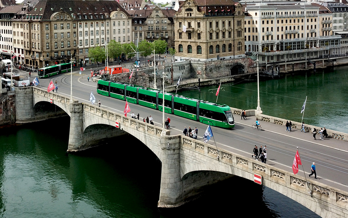 Tramway vert sur un pont au-dessus d'une rivière à Bâle